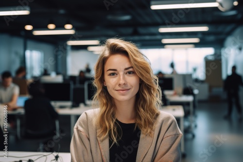 Smiling portrait of a young hipster woman in office