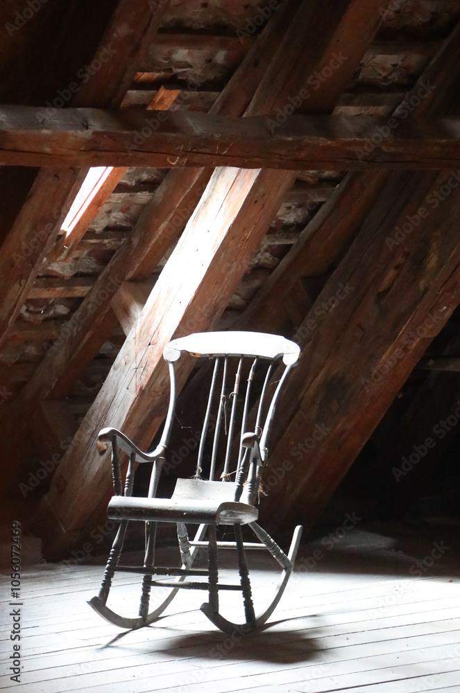wooden rocking chair abandoned in a dusty attic with no people which is a symbol of a bit of nostalgia wooden rocking chair abandoned in a dusty attic with no people which is a symbol of a bit of nostalgia