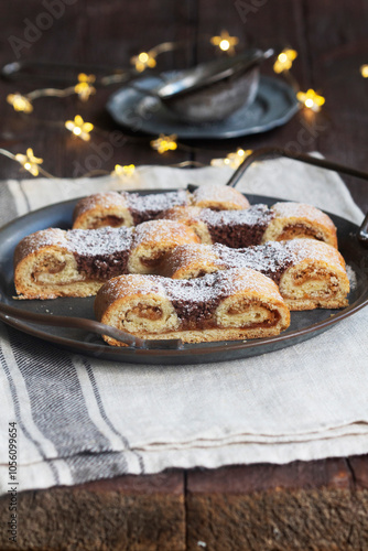 Obraz na płótnie Grandfather's mustache cookies made from shortcrust pastry filled with nuts, jam and cocoa, Christmas toys and garland. w salonie