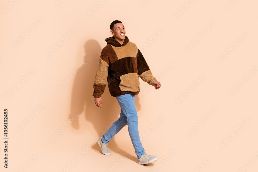 Photo of positive nice man wear trendy clothes going street empty space isolated on beige color background Photo of positive nice man wear trendy clothes going street empty space isolated on beige color background