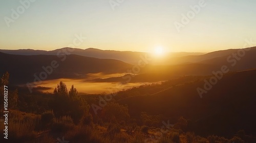 A beautiful sunrise over a valley with fog.