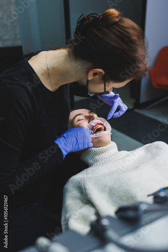 Bracket system on women's teeth. Installation of braces to align teeth. Oral care