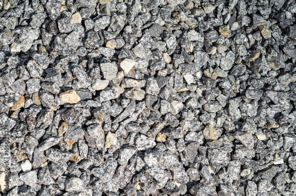 Abstract background of small stones. Gray crushed stone , scattered in an embankment. Landscape design. Abstract background of small stones. Gray crushed stone , scattered in an embankment. Landscape design.