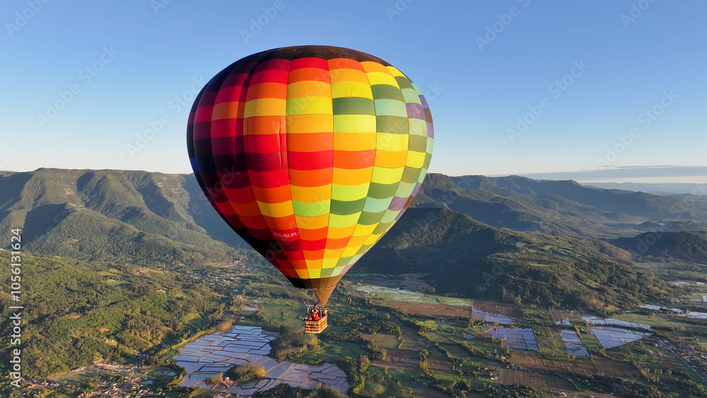 Naklejka premium Colorful Balloon At Praia Grande In Santa Catarina Brazil. Hot Air Balloon Flying. Beautiful Skyline. Rice Field Scenery. Colorful Balloon At Praia Grande In Santa Catarina Brazil. Countryside Scene. 