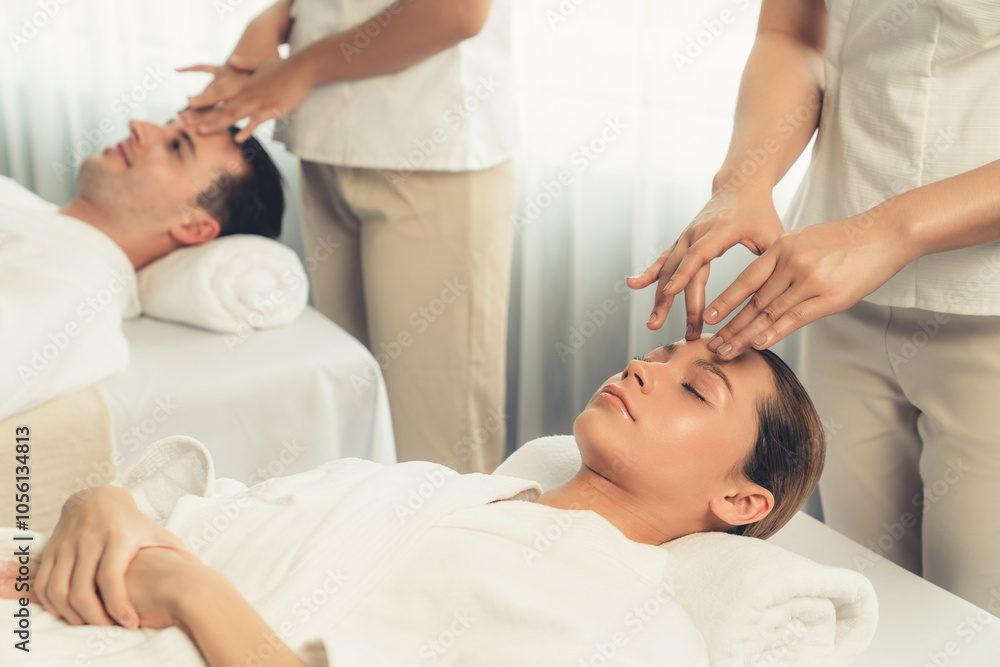 Obraz premium Caucasian couple enjoying relaxing anti-stress head massage and pampering facial beauty skin recreation leisure in dayspa modern light ambient at luxury resort or hotel spa salon. Quiescent