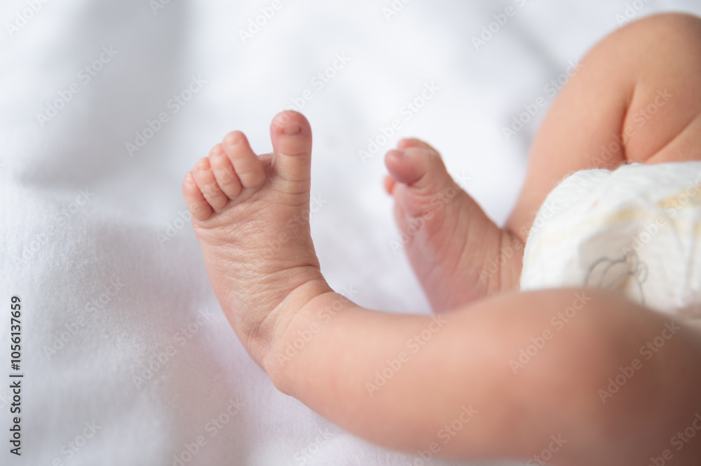 A newborn's tiny feet rest gently on a plush white surface, showcasing their delicate toes and soft skin, embodying innocence and tranquility in a warm, cozy atmosphere. A newborn's tiny feet rest gently on a plush white surface, showcasing their delicate toes and soft skin, embodying innocence and tranquility in a warm, cozy atmosphere.