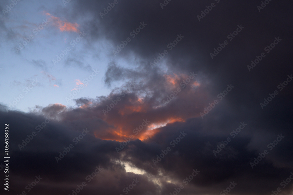 Sky with dark clouds at sunset with some clearings horizontally Sky with dark clouds at sunset with some clearings horizontally
