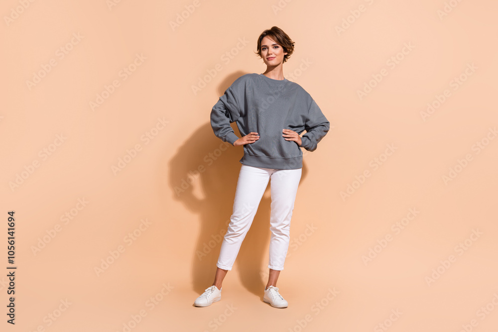 Full size photo of pretty young girl confident posing model dressed stylish gray outfit isolated on beige color background Full size photo of pretty young girl confident posing model dressed stylish gray outfit isolated on beige color background