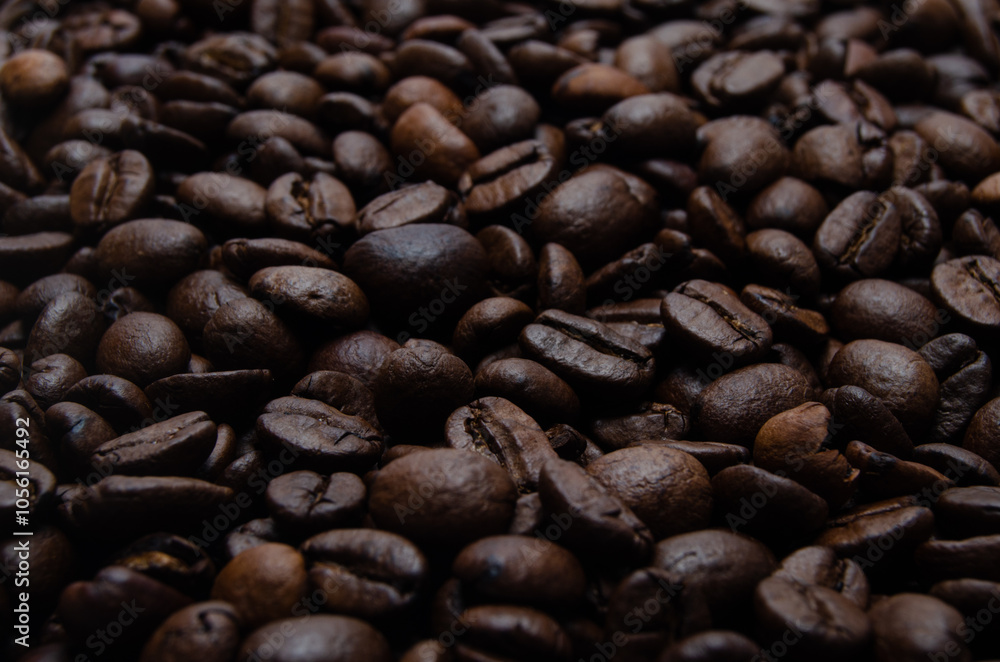 A pile of coffee beans. All stacked together, waiting to be ground into a delicious cup of coffee. A close-up shot of roasted coffee beans. Different types of delicious coffee beans. A pile of coffee beans. All stacked together, waiting to be ground into a delicious cup of coffee. A close-up shot of roasted coffee beans. Different types of delicious coffee beans.