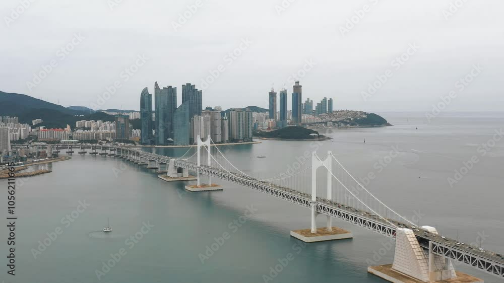 BUSAN, SOUTH KOREA - OCTOBER 20, 2024: Aerial view of the city skyline showcasing modern architecture and the iconic bridge connecting the coast BUSAN, SOUTH KOREA - OCTOBER 20, 2024: Aerial view of the city skyline showcasing modern architecture and the iconic bridge connecting the coast