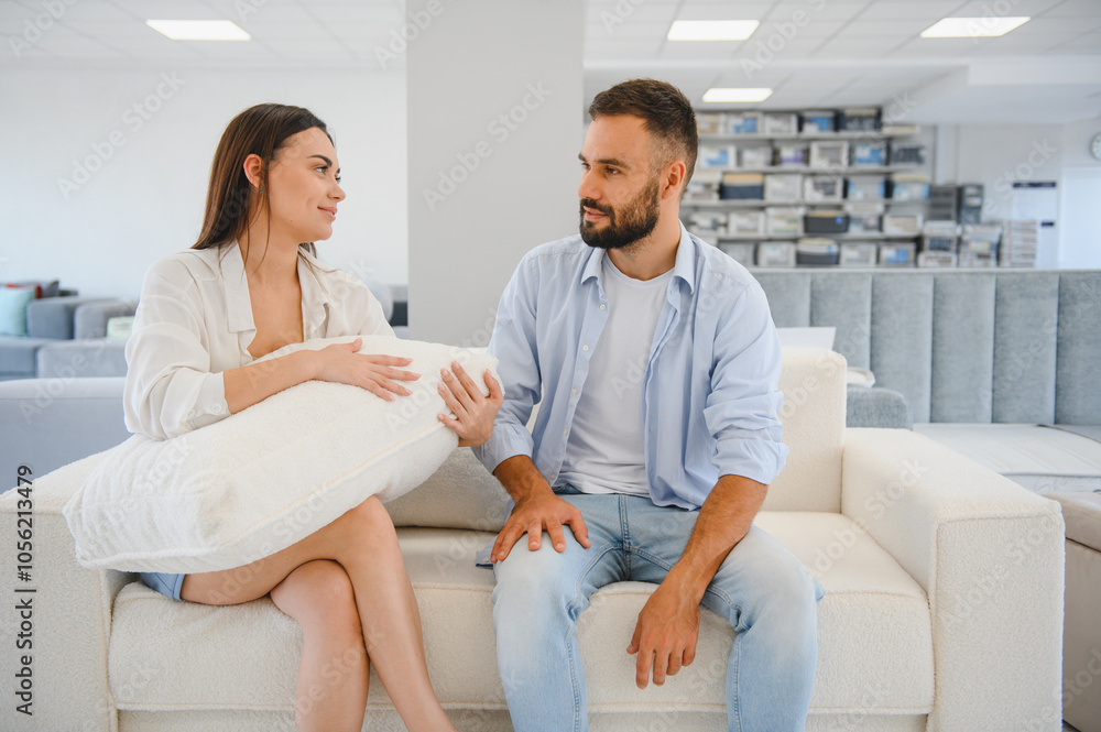 Couple choosing sofa and pillows at furniture store Couple choosing sofa and pillows at furniture store