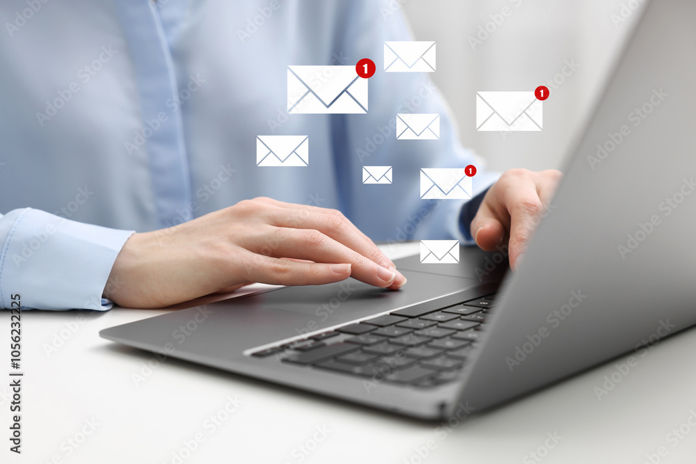 Woman using laptop at table, closeup. Envelopes as symbol of message over computer Woman using laptop at table, closeup. Envelopes as symbol of message over computer