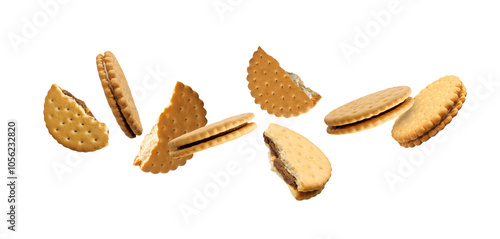 Tasty broken sandwich cookies in air on white background photo