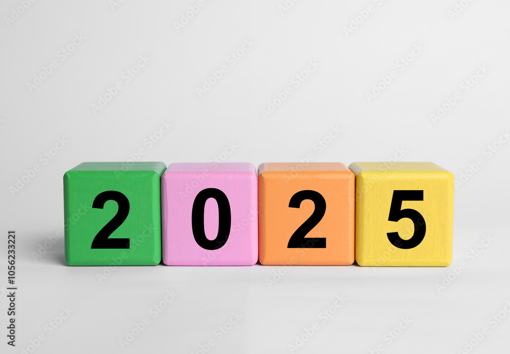 2025 New Year, colorful wooden cubes with numbers on white table, closeup 2025 New Year, colorful wooden cubes with numbers on white table, closeup