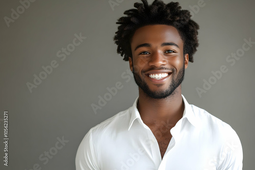 Young man with a bright smile, dressed in a white shirt. high quality