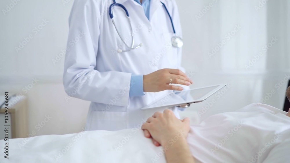 Doctor consulting patient with digital tablet in hospital room. Healthcare professional providing care Doctor consulting patient with digital tablet in hospital room. Healthcare professional providing care