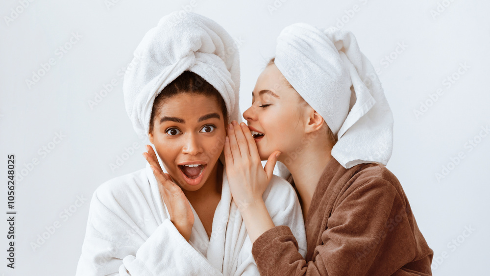It cannot be real. Two multiethnic girlfriends with wrapped heads in bathrobes sharing gossips while having spa day at home, panorama It cannot be real. Two multiethnic girlfriends with wrapped heads in bathrobes sharing gossips while having spa day at home, panorama