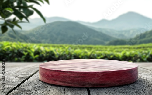 A round cheese on a rustic wooden surface, surrounded by lush green hills, creating a serene countryside atmosphere.