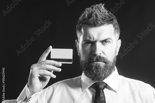 Canvas Print Serious bearded businessman, banker showing credit, debit or payment card