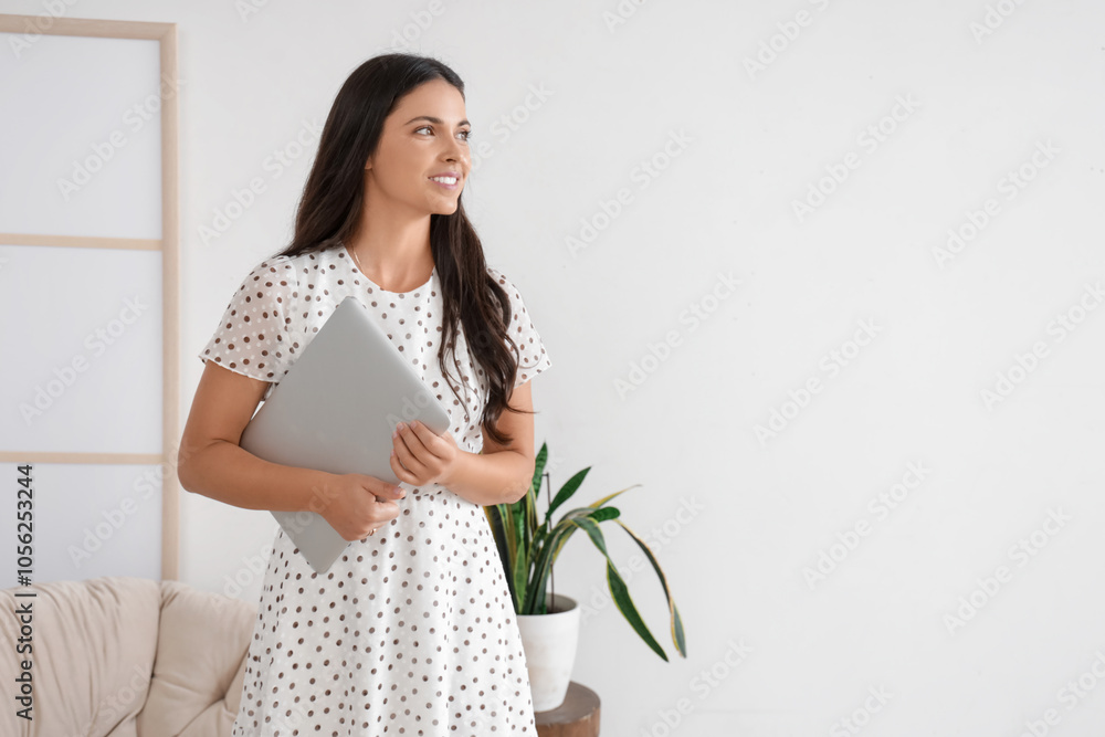 Pretty young woman with modern laptop at home Pretty young woman with modern laptop at home