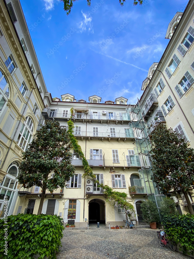 Courtyard of a building in the center Turin, Italy against blue sky