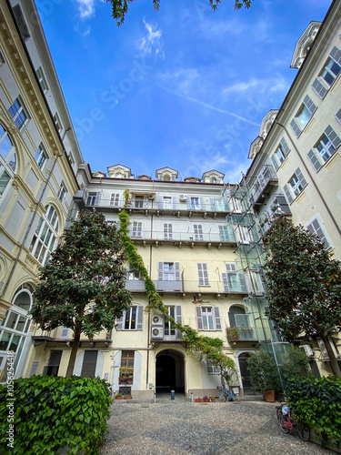 Courtyard of a building in the center Turin, Italy against blue sky