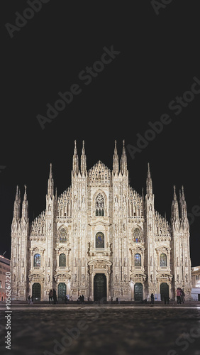 Obraz na płótnie Low angle view of illuminated Milan Cathedral (Metropolitan Cathedral-Basilica of the Nativity of Saint Mary), Italy and its front facade with incidental people at night w salonie