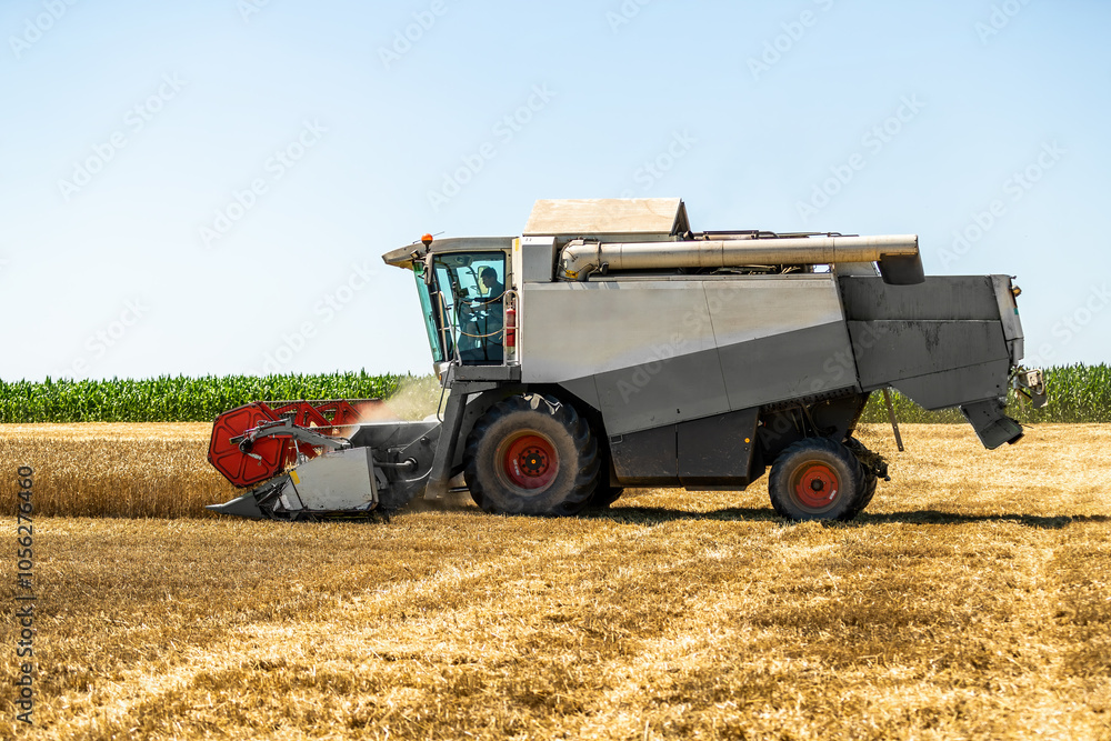 Modern combine harvester at work during the wheat harvest season Modern combine harvester at work during the wheat harvest season