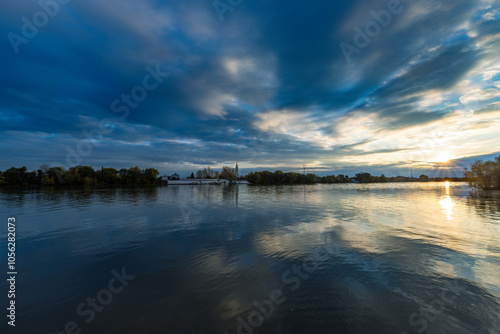 The sky is cloudy and the water is calm