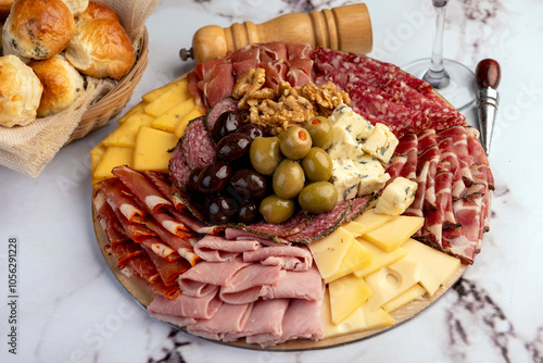 cold cuts table with assorted cheeses, Sardinian provolone and flavoured with oregano and olives, homemade bread with loin, ham, pork shoulder, bacon, salami, mortadella with nuts and a variety of col