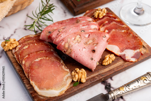 cold cuts table with assorted cheeses, Sardinian provolone and flavoured with oregano and olives, homemade bread with loin, ham, pork shoulder, bacon, salami, mortadella with nuts and a variety of col