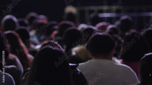 silhouette of people at a concert, group of hispanic people waiting for the concert to start