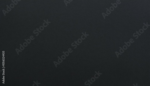 Close-up of a charcoal black paper texture, displaying soft, subtle grains that create a refined, sophisticated background