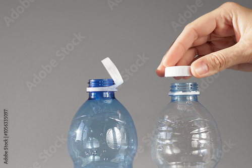 Hand Demonstrating The New Tethered Caps On Plastic Water Bottles, Designed To Reduce Plastic Waste. New Eu Regulation