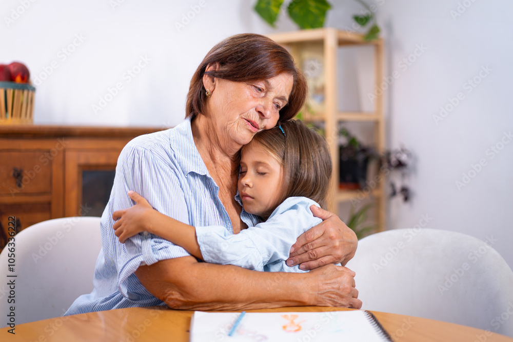 Fototapeta premium Cute girl embracing loving grandmother as they spending quality moment at home, little girl is sharing heartfelt moment of bonding with elderly woman 