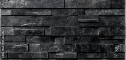 A textured black stone wall featuring varying sizes and shapes of stone pieces.