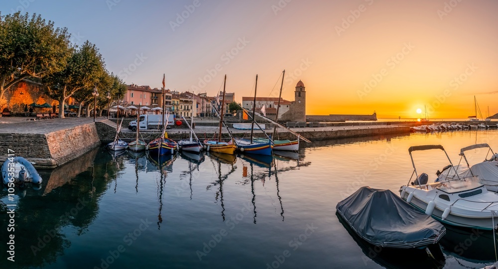 Traditional Catalan Fishing Boats In The Harbor Of The City Of Collioure, With The Church Of Notre-dame-des-anges Visible In The Background, France.