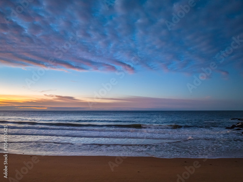 Winter seascape views over the beach with high and medium cloud cover photo