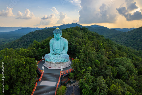 Beautiful aerial view of Great Buddha or Kamakura Daibutsu statue at sunset time in Wat Phra That Doi Phra Chan temple, Lampang, Thailand. photo