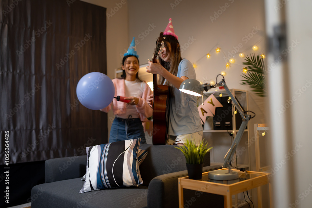 Fototapeta premium Two Asian women in room with Ciematic lighting celebrate important events such birthdays Christmas