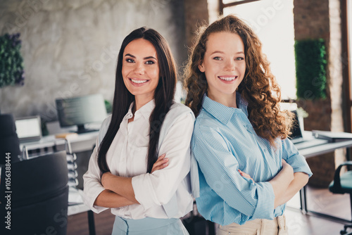 Photo of successful two attractive women office workers confident team folded arms workplace indoors
