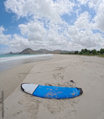Photography A blue surfing or peddle board at the beach