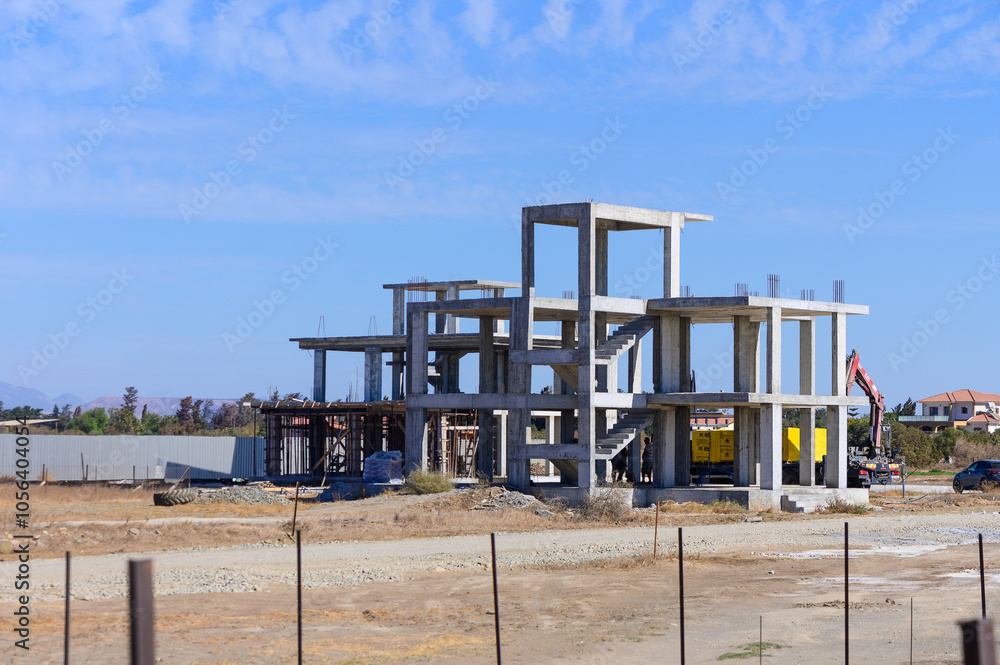 New construction progress on a modern building under clear blue skies in a developing neighborhood New construction progress on a modern building under clear blue skies in a developing neighborhood