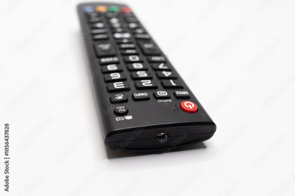 TV remote control with a detailed keypad layout, designed for household use, displayed on a plain white background, ideal for electronics and media concepts. TV remote control with a detailed keypad layout, designed for household use, displayed on a plain white background, ideal for electronics and media concepts.