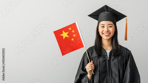 Chinese Graduate's Joyful Celebration: A portrait of a smiling young Chinese woman, wearing a graduation gown and cap, proudly holding a Chinese flag.