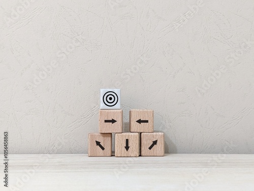 wooden cube and arrows of different directions with the aim of the goal icon. business finance