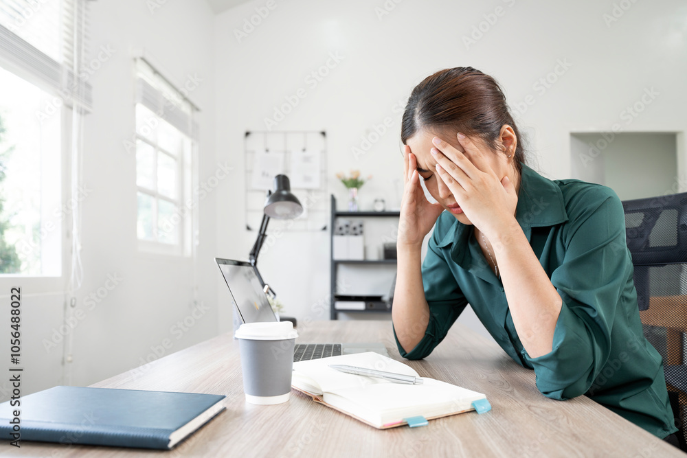 Stressed woman in home office holding head while working on laptop and documents. workplace, business, deadline, multitasking Stressed woman in home office holding head while working on laptop and documents. workplace, business, deadline, multitasking