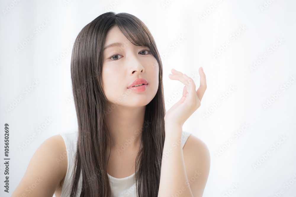 Young sexy cute woman close up looking at camera in mock pose with hand on chin and cheekbones