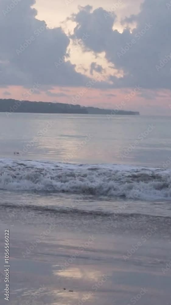 View of sunset and waves on the beach in the afternoon towards night in Kuta Bali View of sunset and waves on the beach in the afternoon towards night in Kuta Bali