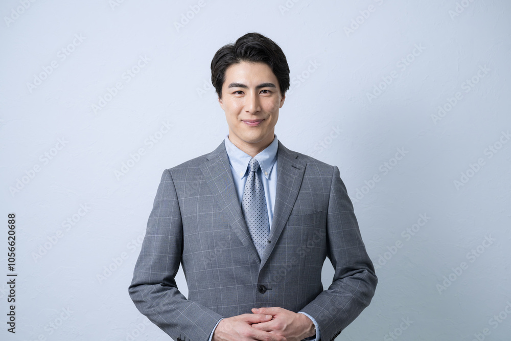 Handsome, fresh, young, sincere-looking businessman in suit, looking at camera in front of him, light blue background
Handsome, fresh, young, sincere-looking businessman in suit, looking at camera in front of him, light blue background